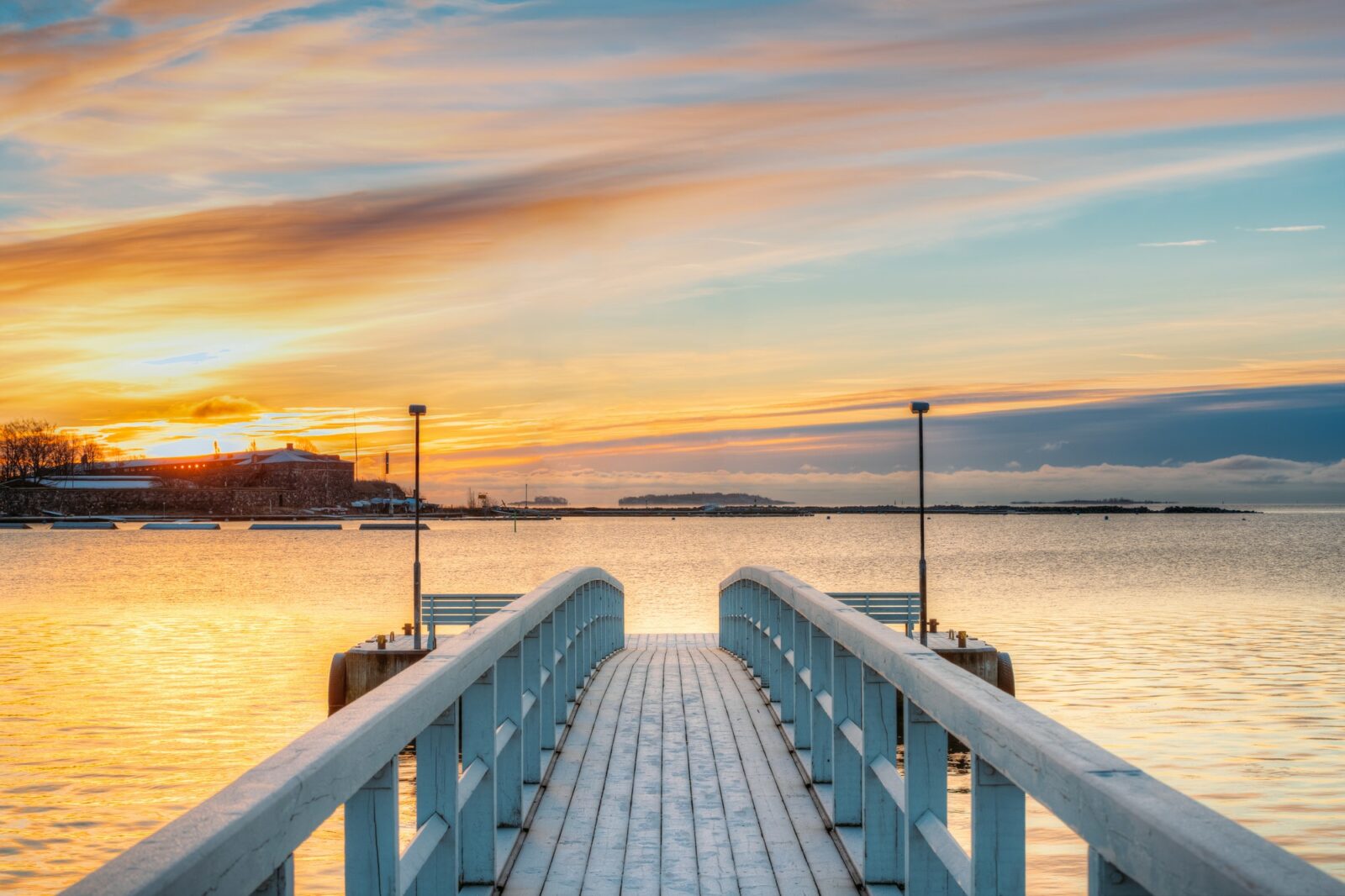 Old Frosted Wooden Boards Pier On Calm Water Of Lake Or River Or