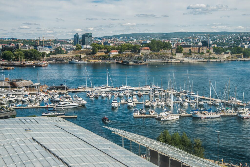 OSLO, NORWAY - 28 JULY, 2018: beautiful city view and boats in harbour at Aker Brygge district, Oslo