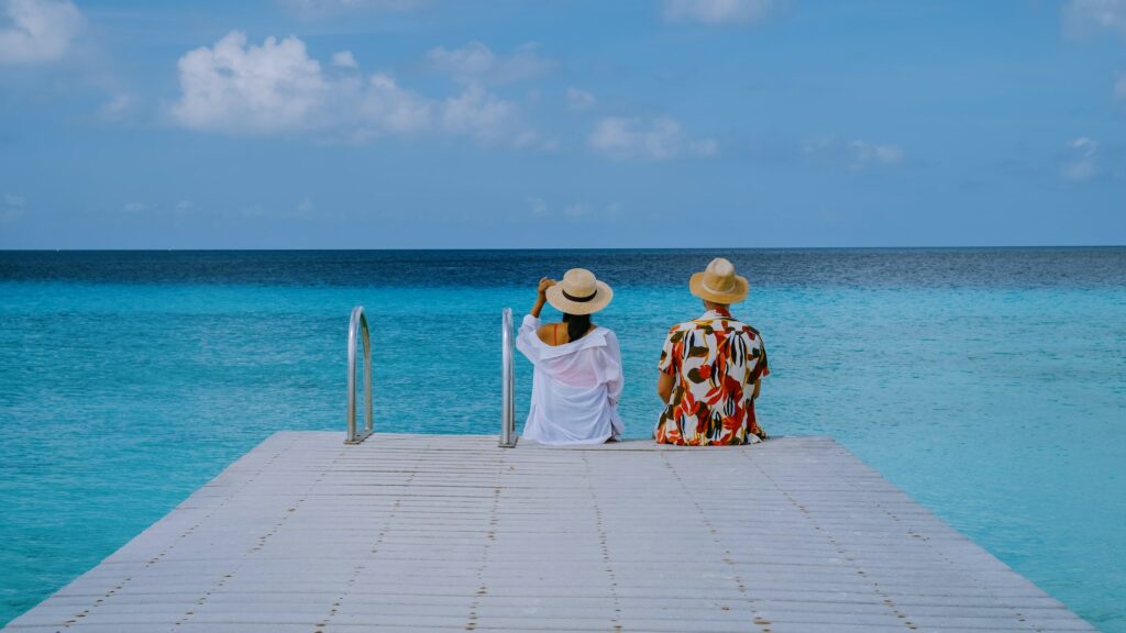 couple visit Playa Porto Marie beach Curacao, white tropical beach with turqouse water ocean