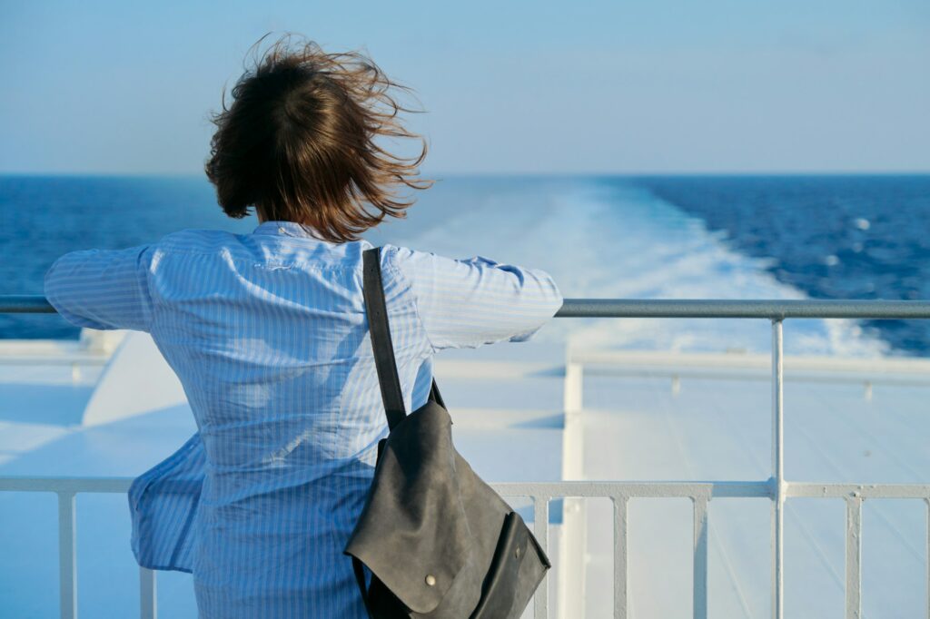 Back view of a woman enjoying a sea cruise