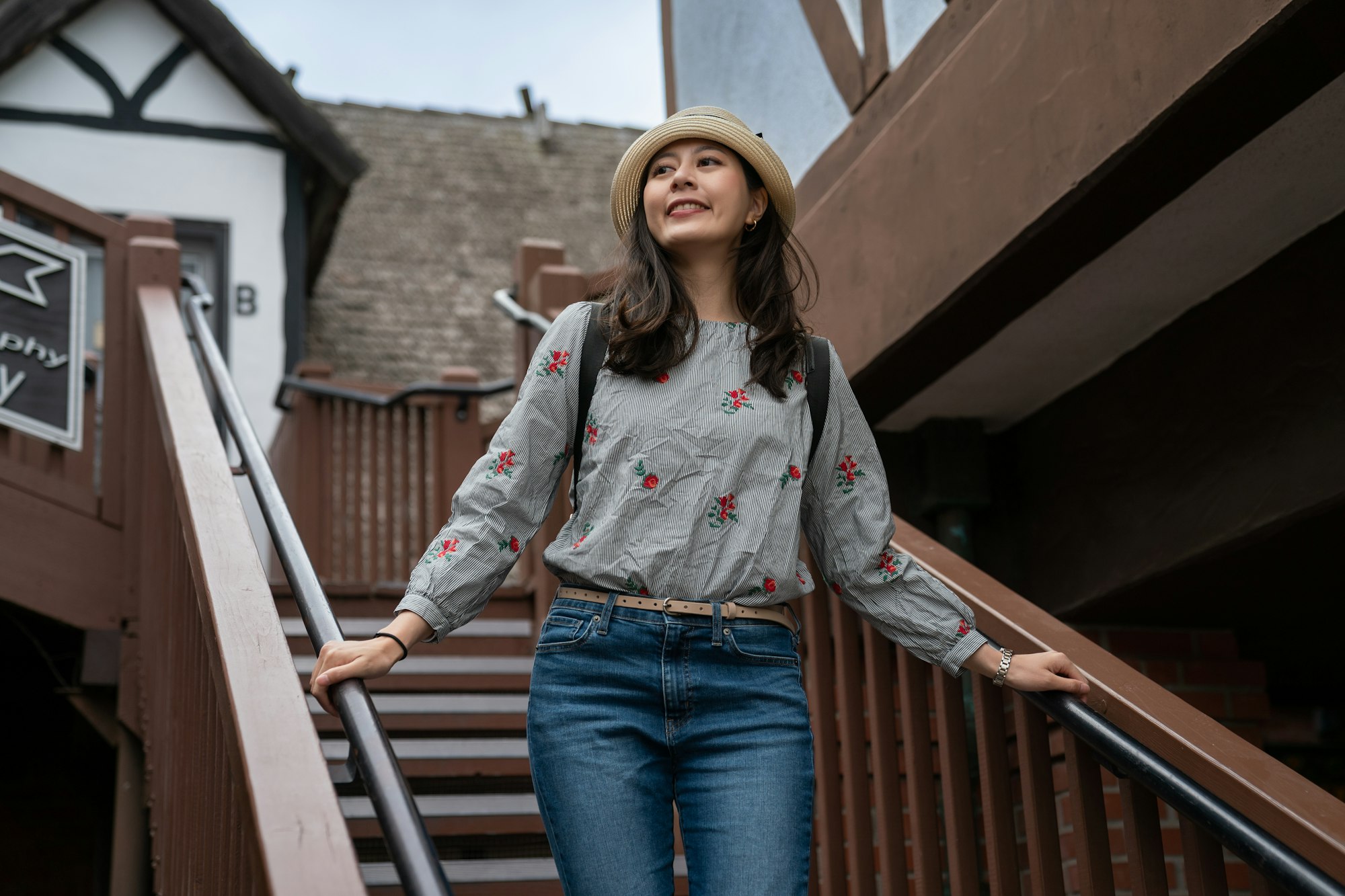 girl admiring rural Danish building on staircase